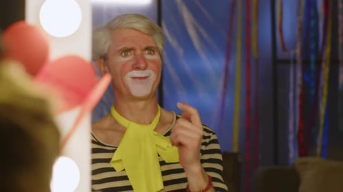 Clown Applies White Makeup in Dressing Room Mirror