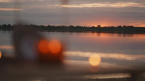 Beautiful Sunset Over Calm Lake In Summertime Blurred Burning Candles In Foreground