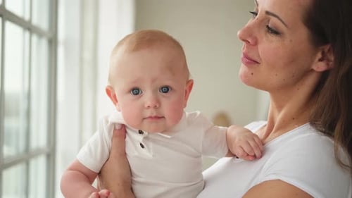 Mother Holds Adorable Baby in Natural Light