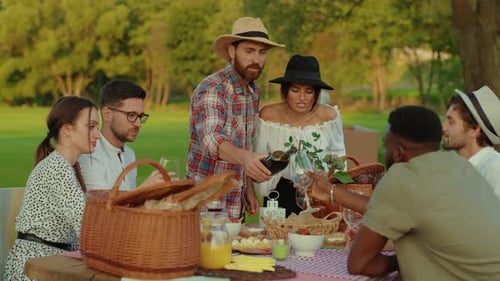 Enjoying an Outdoor Picnic Gathering with Friends in a Beautiful and Scenic Park Setting