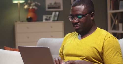 Man Working on Laptop Computer in Living Room