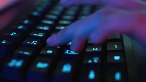 Close-up on the Hands of the Gamer Playing in the Online Video Game. Stylish Arcade Neon Bright Red