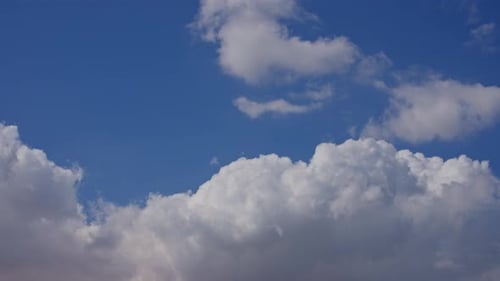 Clouds Moving Across a Vivid Blue Sky
