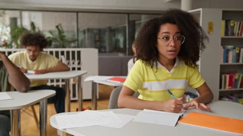 Young Adults Studying in a Library