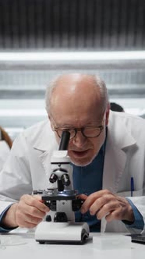 Senior Scientist Using Microscope in Modern Laboratory