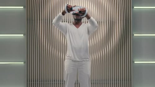 Man Experiencing Virtual Reality with Headset and Controllers