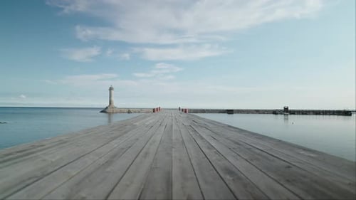 Landscape With Empty Wooden Pier In Beautiful Harbor Near Lighthouse In Sunny Morning Nobody