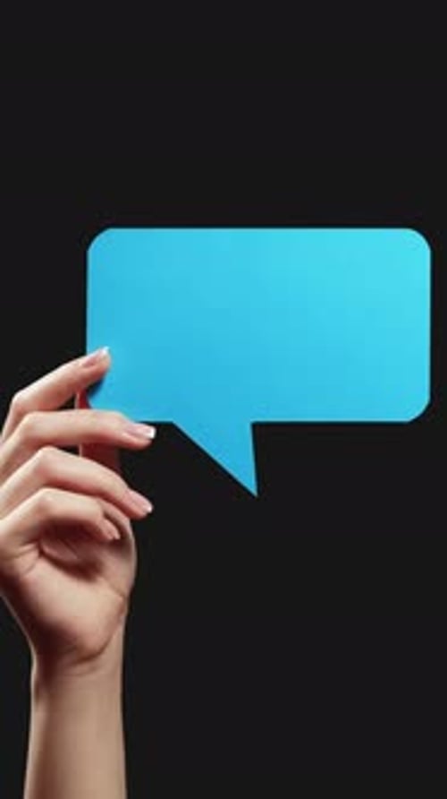 Hand Holding Blue Speech Bubble on Black