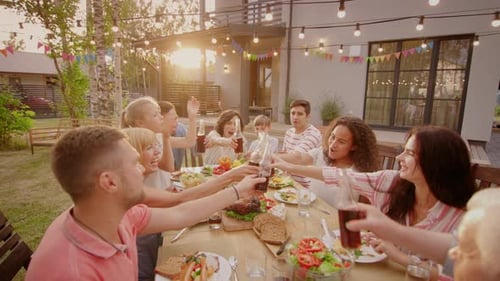 Family and Friends Toasting at an Outdoor Dinner