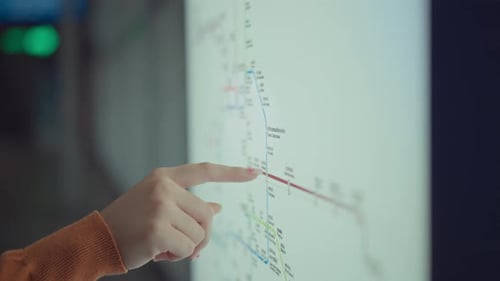 Finger of woman pointing on the Bangkok railway map .Find the route of railway in Bangkok