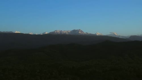 Aerial Mountain Range with a Few Snow Capped Mountains in the Distance