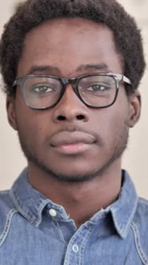 Close-Up Portrait of Young Man with Glasses