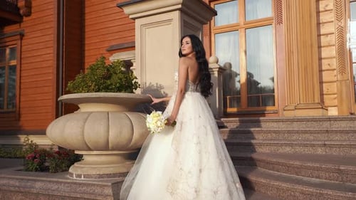 Beautiful bride in wedding dress with bare shoulders in park