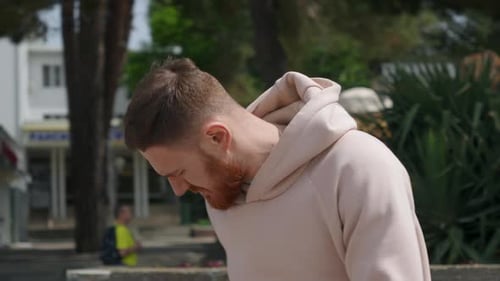 Guy Walks Down the Street in a Sweater and Answers a Call on His Phone Bearded Man Take Phone in