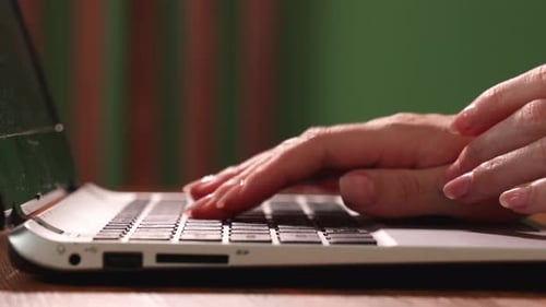 Woman Typing on Laptop Computer Keyboard Close Up