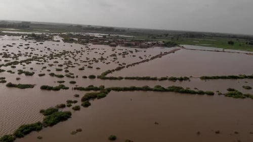 Aerial drone forward moving shot of severe river flooding in Sindh, Pakistan at daytime.