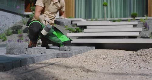 Laying Pavers in a Modern Garden Landscape in Early Morning