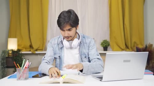 Young Adult Studying at Desk at Home