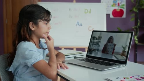 Young Girl Attending Online Class at Home