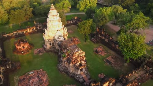 Drone footage of ruins of an ancient Asian temple in Thailand at sunrise.