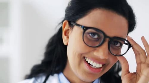 Smiling Young Woman Doctor in Glasses Posing