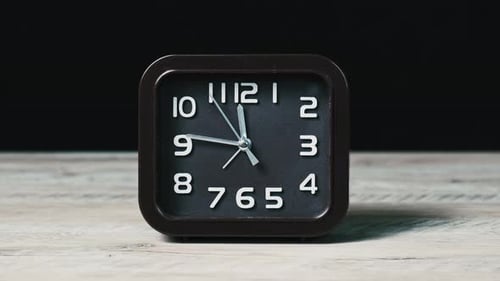 Analog Clock on Wooden Table and Black Background Show Time