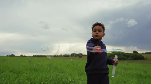 Boy Playing with Soap Bubbles