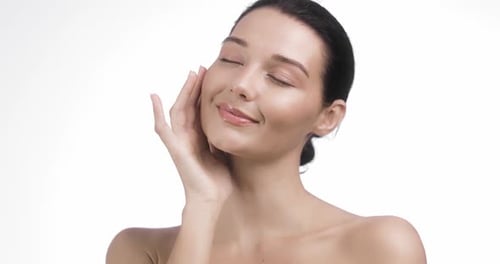 Woman Touching Face Gently in a Beauty Shot