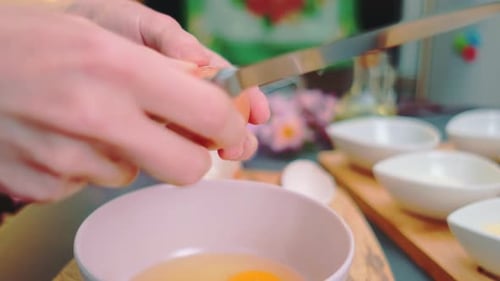 Cracking Egg into a Pink Bowl Close Up