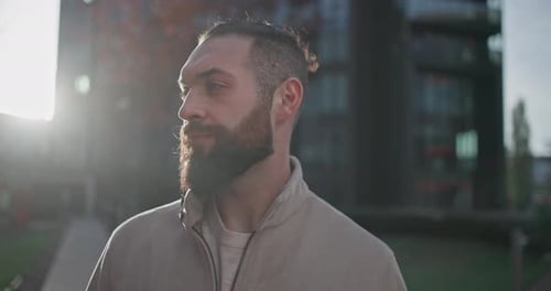 Bearded Man Looks Upward Outside