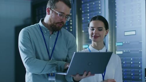 Data Center Engineers Using Laptop in Server Room