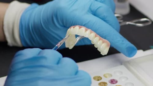 Dental Technician Working on Denture in Lab