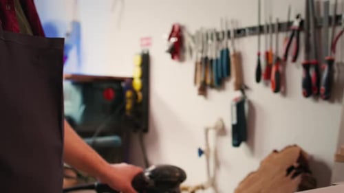Person Attaching Sandpaper to an Electric Power Sander