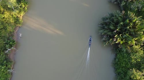 Engine boats transporting sand around the river in the waters of the forest area