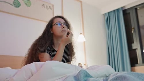 Quiet Night with Popcorn Serene Woman Enjoys Peaceful Hotel Stay Tranquil Scene of Woman Savoring