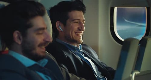 Cinematic shot of smiling business partners or colleagues in formal apparel are discussing new st