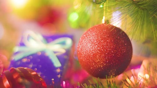 Close Up Red Ball on the Background of a Blue Gift Box Radiance of Garlands