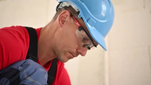 Construction Worker Pays Attention to Detail on an Urban Site During Daylight
