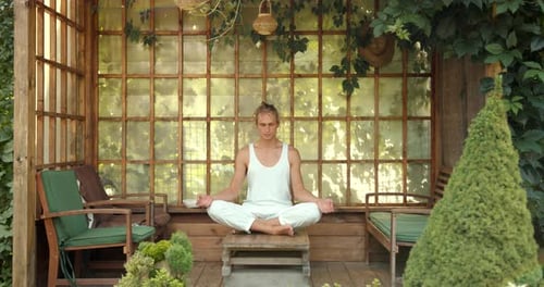 Man Meditating in Peaceful Green Gazebo