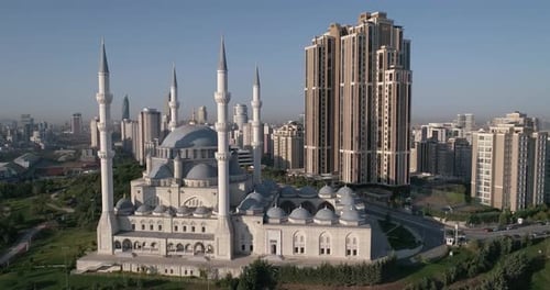 Aerial video flies around. above a mosque with four minarets