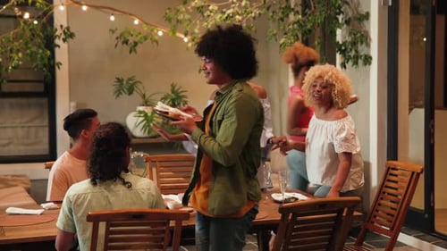 Group of Friends Enjoying Evening Meal Outdoors