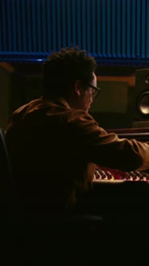 Vertical Video African American Producer Working at Mixing Panel in Recording Studio