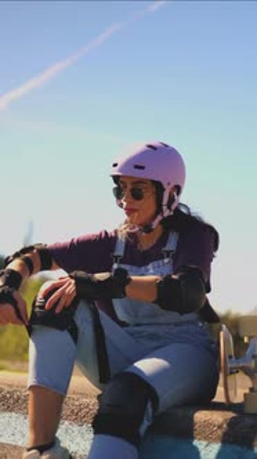 Woman Puts on Protective Roller Skating Gear