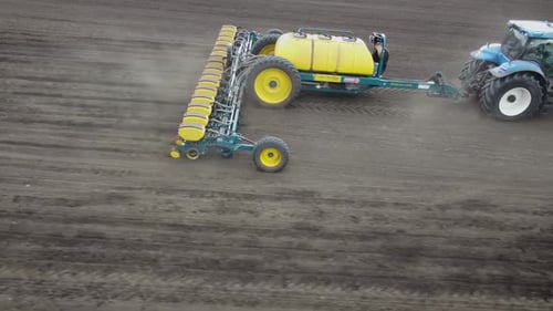 Blue tractor OA working on the field in Ukraine
