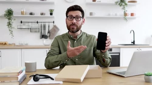 Man Unboxes New Phone in Modern Kitchen