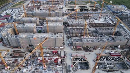 drone fly above huge construction site with yellow crane and truck working on urban development in m