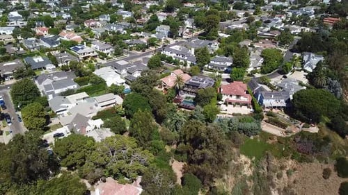 Aerial tilt up shot of luxury american neighborhood with Swimming pool and palm trees. Housing area