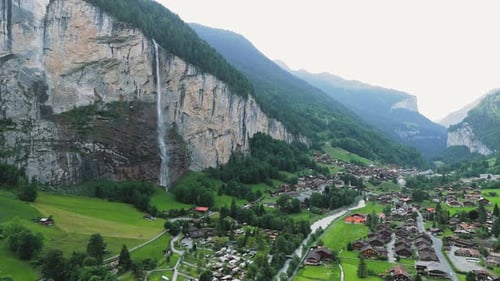 Flying around the waterfall Spissbachfall in Lauterbrunn Grindelwald Switzerland and its valley