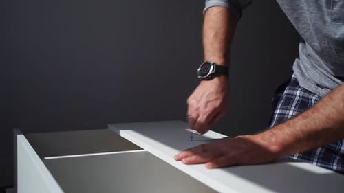 Caucasian Man Assembles Furniture Fit Table or Mount Wardrobe