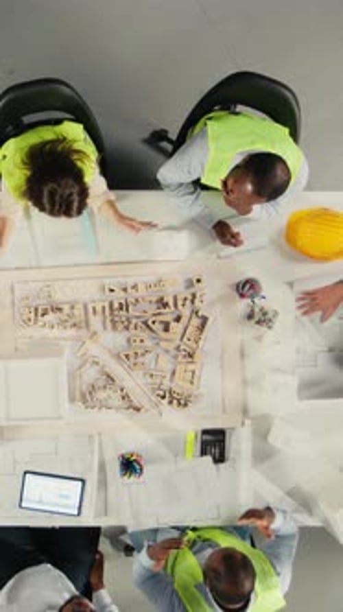 Vertical Video Top Down View Zoom in of Real Estate Professionals Using Architectural Software